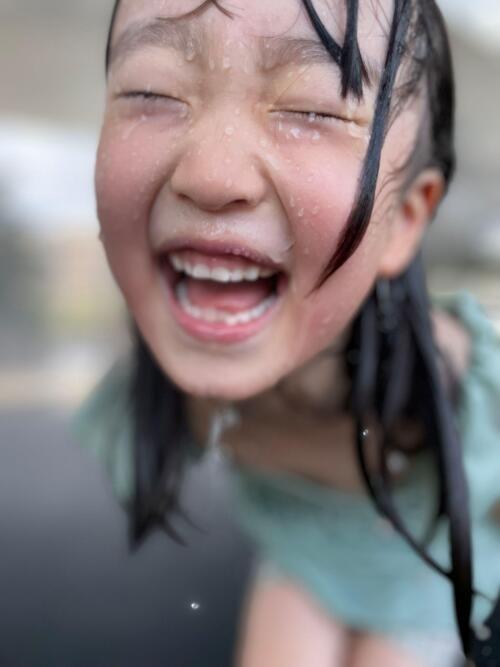 水を浴びている子どもの写真