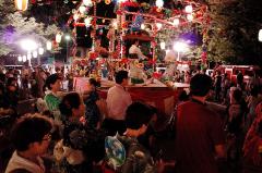 A circle of people performing a Bon festival dance